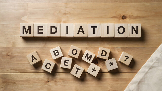 Mediation word spelled with wooden blocks on a light wooden background