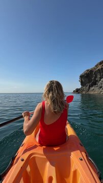 Kayaking kayaking ocean woman paddling kayak on open sea during summer vacation enjoying outdoor water activities and peaceful coastal nature views