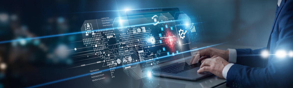 Operations manager working on laptop focusing on productivity enhancements. She audits internal workflows and team schedules, implementing strategies to maximize output and reduce wasted time.