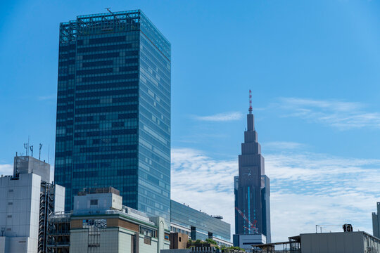 SHINJUKU-KU, TOKYO, JAPAN - AUGUST 25, 2026: NTT Docomo Yoyogi Building tower seen over buildings in Shinjuku-ku, Tokyo.