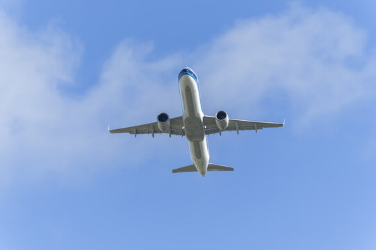 Passenger airplane flying overhead in clear blue sky
