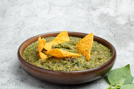 Green Salsa with Tortilla Chips in a Bowl