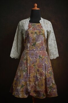 Floral dress with gray bolero displayed on a dress form