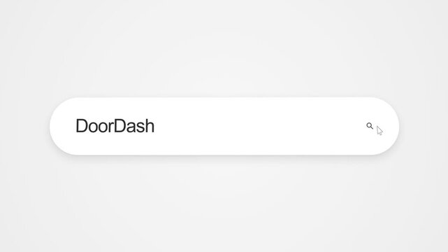 Typing DoorDash into an internet search bar on a computer screen, illustrating online food delivery research, app services and web browsing.
