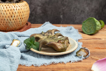 Water Caltrop on Rustic Wooden Table with Mint © TranNgoc