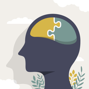 Mental health concept with jigsaw puzzle pieces forming the brain within a human profile silhouette