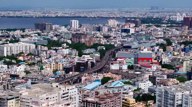 urban density with Elevated Metro, skyline and Hussain Sagar lake at ameerpet, hyderabad, telangana, india. day time, trucking shot, drone shot, 4k.