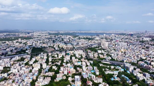 Aerial view of Ameerpet with madhura nagar and Hussain Sagar lake at hyderabad, telangana, india. day time, semi circle shot, drone shot, 4k.