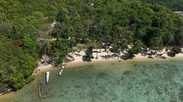 # Microstock Description Aerial view of Alano Beach on Karimunjawa Island, Indonesia, featuring pristine white sand, turquoise ocean water, and a tranquil tropical coastline.