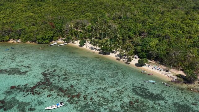 # Microstock Description Aerial view of Alano Beach on Karimunjawa Island, Indonesia, featuring pristine white sand, turquoise ocean water, and a tranquil tropical coastline.