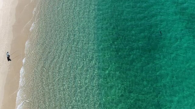 Aerial top down view of a fly fisherman casting from the beach in La Ventana, Mexico.