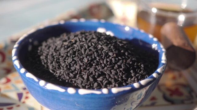 Black cumin seeds and oils on a table 