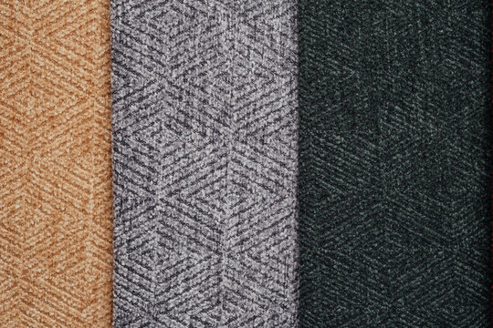 Three textured fabric swatches with geometric patterns in brown, grey, and dark green