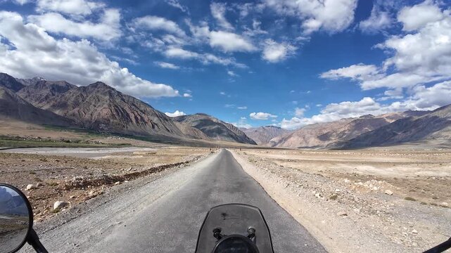 Padum, India : Point of view footage of motorcyclist ride on the asphalt road of Padum, high-altitude mountain road in Ladakh of India showing arid mountain range on sunny day