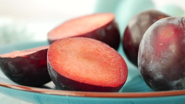 Fresh plums sliced and arranged on a plate