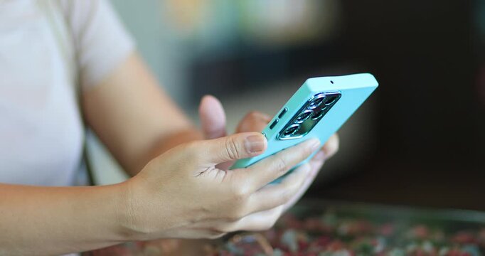 Woman using a smartphone and tapping the screen, mobile technology, communication, social media, online services, digital lifestyle, and mobile applications, close-up