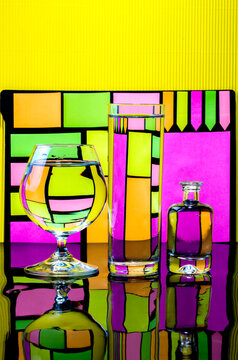 Abstract still life with glassware on colored bright background