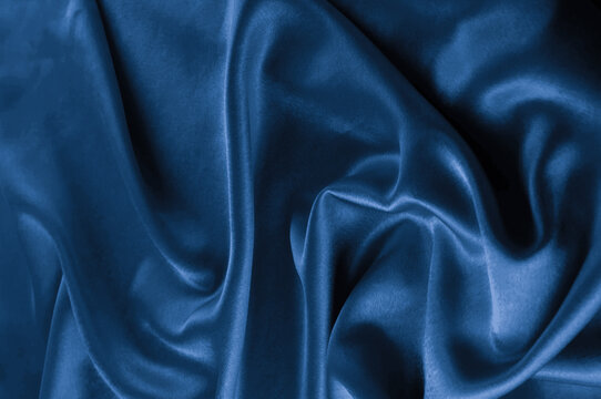 Blue satin fabric texture with soft folds and highlights