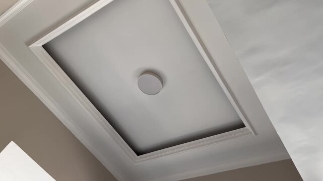 Clean white interior plasterboard ceiling with elegant shadows footage