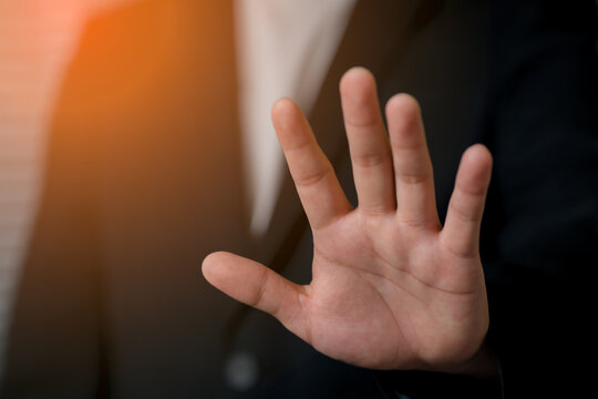 A close-up a business hand with fingers spread, gently pressing against a, highlighted by warm sunlight and natural lighting effects.