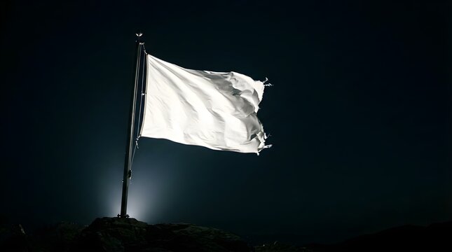 Tattered blank white flag waving on a pole against a dark night sky