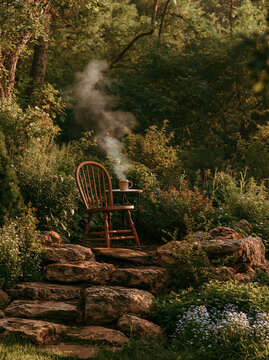 Wooden chair with steaming coffee in lush garden woodland setting, creating peaceful cozy backyard morning coffee corner