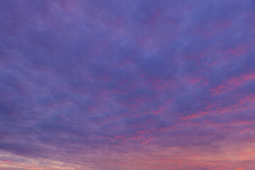 Obraz premium Vibrant Purple and Pink Sunset Sky with Dramatic Clouds,Beautiful twilight sky filled with soft purple, pink, and blue hues, featuring textured clouds during sunset suitable for background and nature 