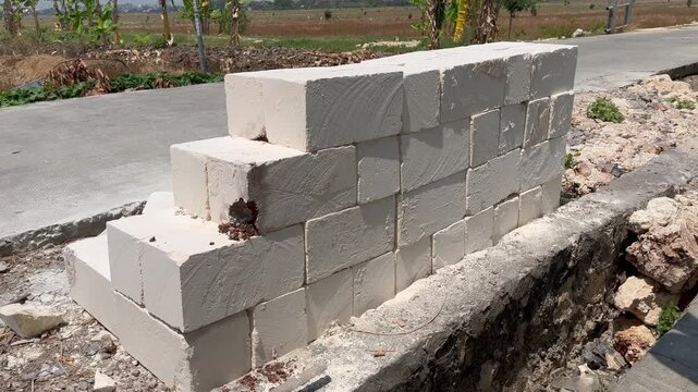 Stacked white lightweight concrete blocks on construction site