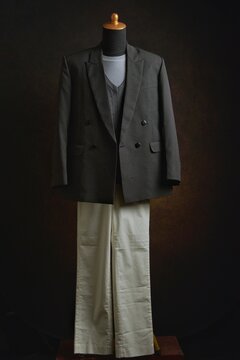 Classic double-breasted blazer and vest with white trousers on a mannequin display