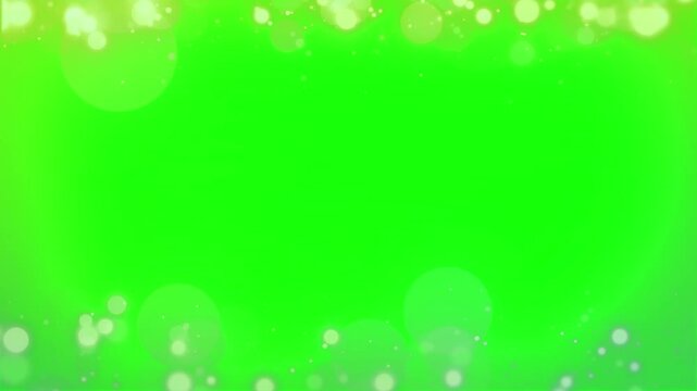 Bokeh light circles create a glowing border along the top and bottom of a bright green chroma key background screen.