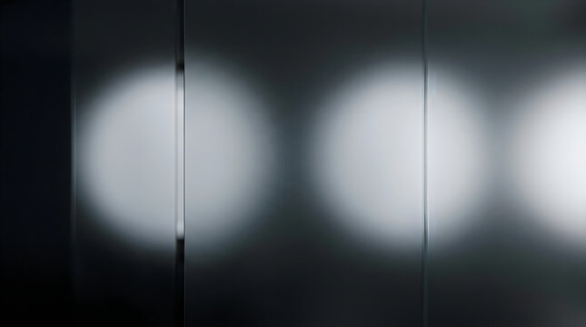 Abstract background featuring multiple soft glowing white circular light spots arranged in a horizontal row against a dark moody and minimalist grey