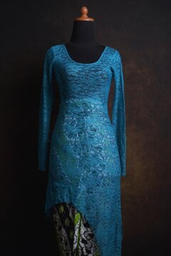 Blue Asymmetric Modern Indonesian Lace Kebaya with black and green batik skirt displayed on a dress form