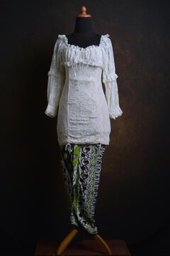 Indonesian Kebaya with Lace Sheer Fabric with Batik Skirt on a Display Mannequin