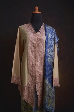 Indonesian Kebaya with Embroidered Lace Accent and Batik Skirt and Shawl Displayed on A Dress Form