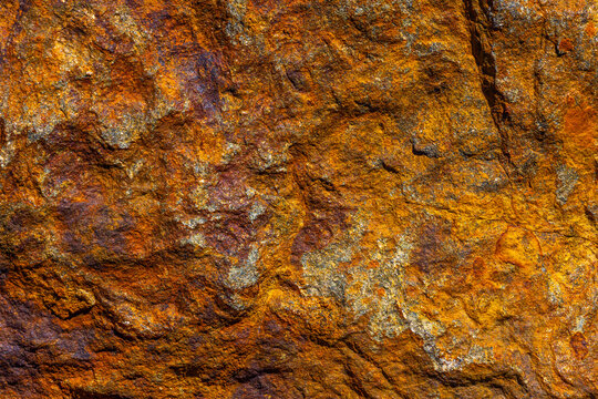 Close-up Textured Iron Rock Surface with Orange and Brown Hues