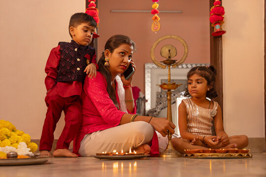 Mother multitasking during Diwali preparations