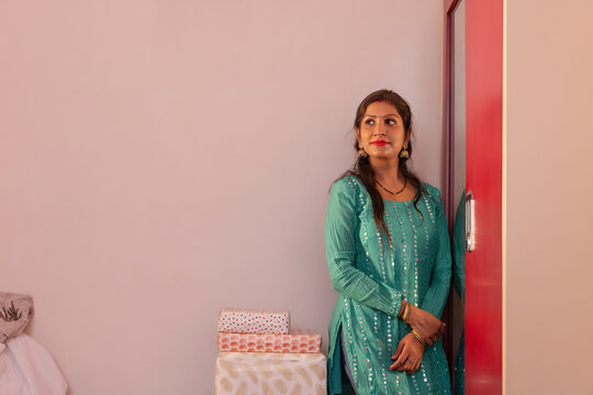 Woman gazing thoughtfully in a cozy room