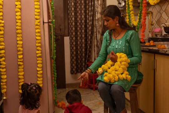 Mother guiding children in festive preparations