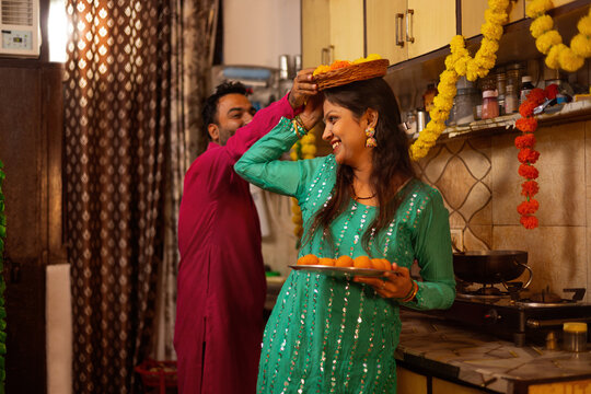 Couple playfully interacting during festive preparations