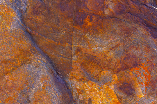 Close-Up of Abstract Iron Rock Texture with Orange and Purple Hues