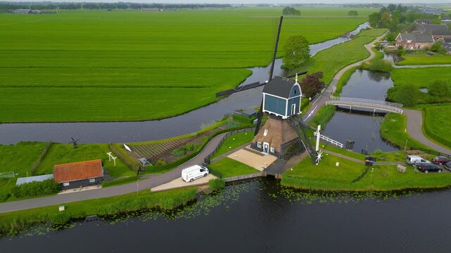 Traditional dutch windmill in a rural landscape aerial view.