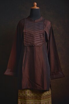 Traditional Baju Kurung with Songket Skirt on a Mannequin Display