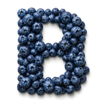 Ripe blueberries covered with water droplets form a bold letter B, creating a healthy fruit alphabet concept.