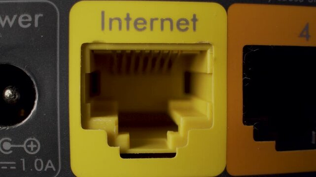 Close up on empty Ethernet ports on a router showing internet and LAN connections.