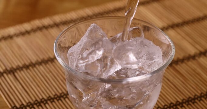 氷の入ったグラスに焼酎を注ぐ