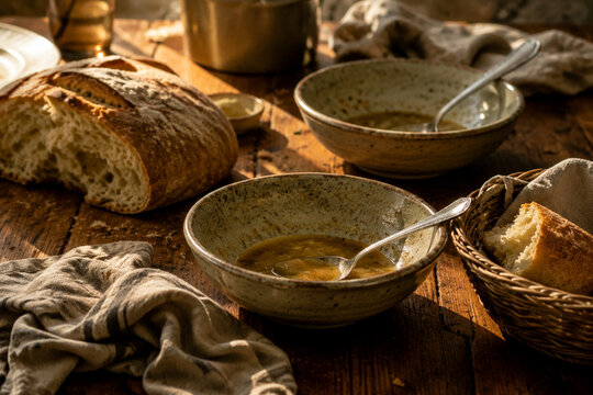 Dinner table with soup bowls and bread remnants, family meal and togetherness concept