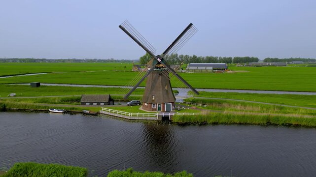 Dutch windmill rotating in the lush green countryside