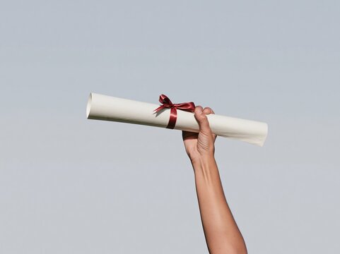 Hand holding a rolled diploma with a red ribbon bow, featuring a soft paper texture and a clean grey background for graduation announcements