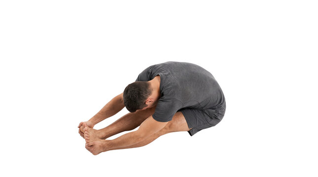 Athletic man performing seated forward bend yoga pose. Fitness male stretching hamstrings in grey sportswear. Healthy lifestyle workout. isolated PNG with Transparent Background