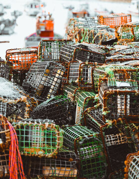 Colorful lobster pots stacked on a busy dock